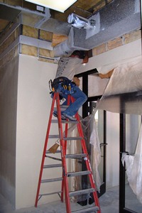 Electrician putting in wire for automatic door opener