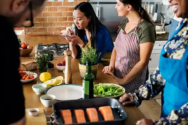 Students gathered around table in cooking class