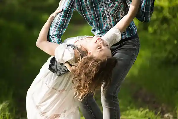 Man dipping young woman in country and western dance