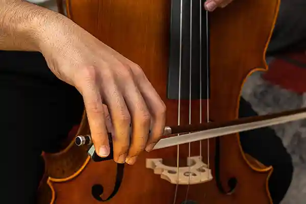 Hands playing a string instrument