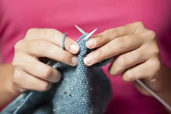 Hands knitting with needles
