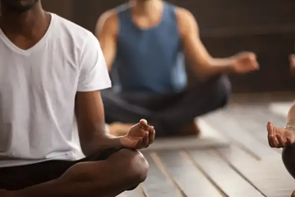 Male students in yoga sitting Mudra position