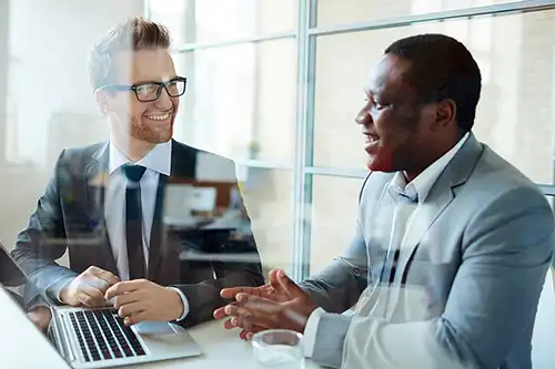 Two Professional Men Talking at Conference Table