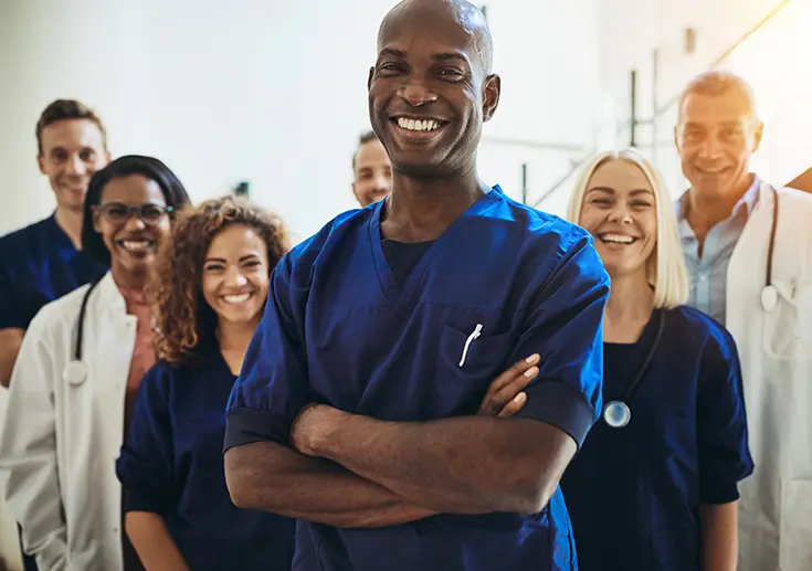 Group of various healthcare staff members standing together.