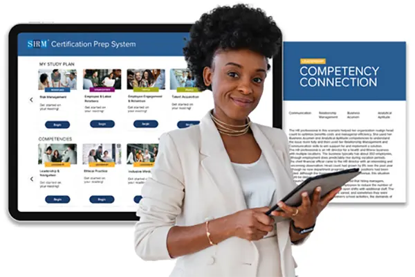 A pretty Black woman holding a tablet in front of a laptop and brochure, advertising the SHRM course