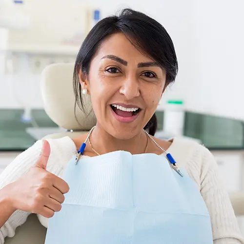 Happy woman sitting in dental chair