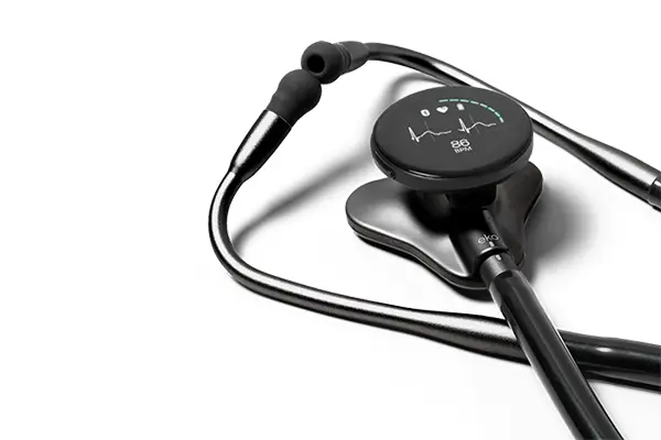An electronic stethoscope with a round digital display, resting against a white background.