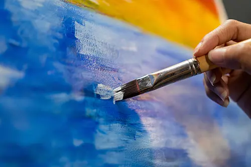 Close up of hand painting on canvas.