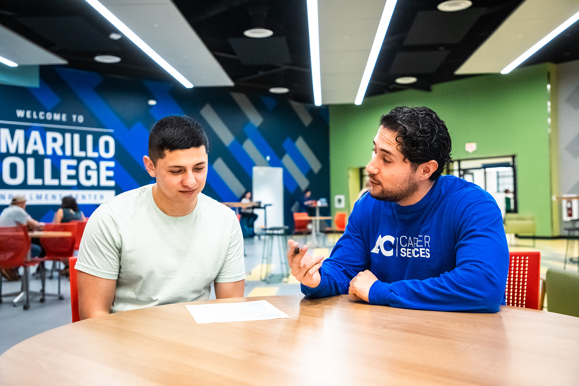 A career services employee helping a student write their cover letter.