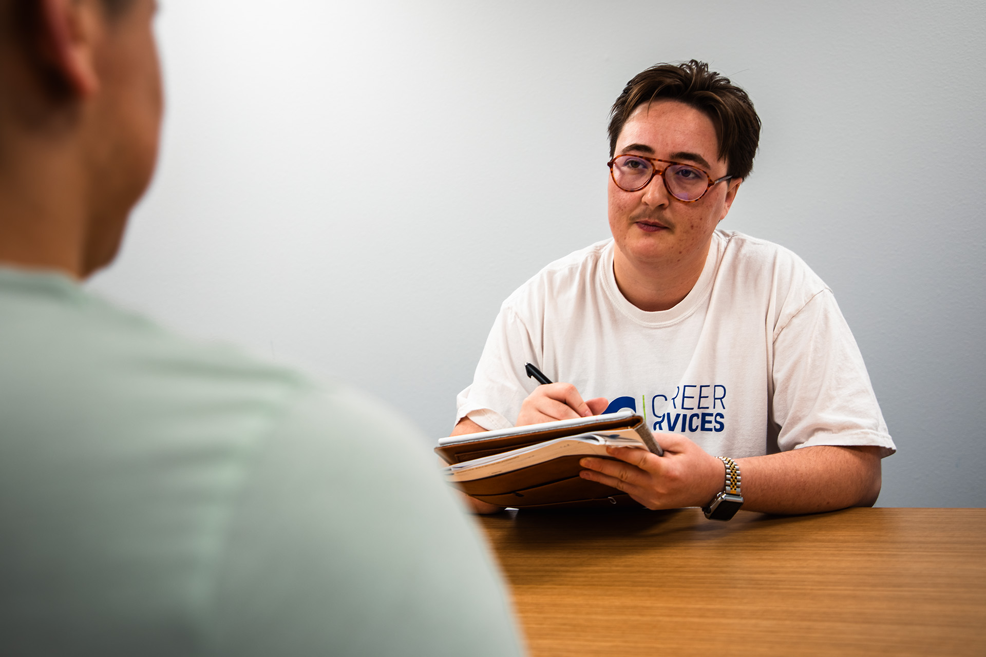 A college employee interviewing a candidate for a student worker position.