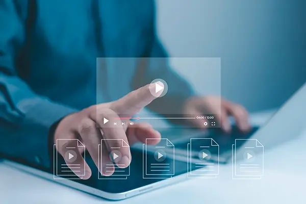 Image represents a concept of online learning; the person touching to navigate a virtual screen