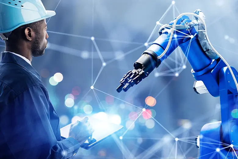 The image depicts a male human worker collaborating with an industrial robotic arm