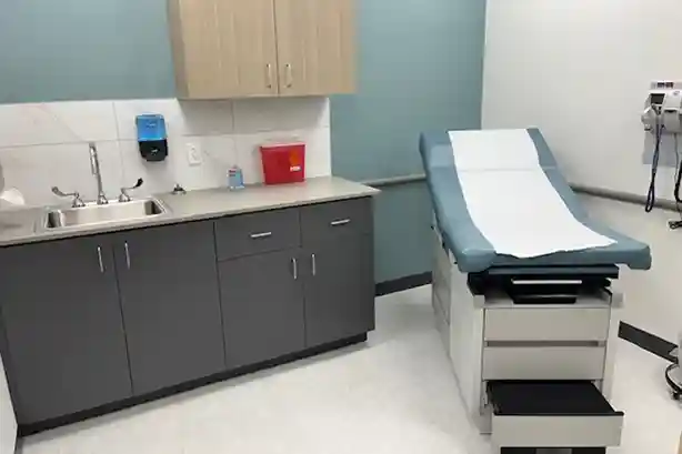 Clinical exam room with bed