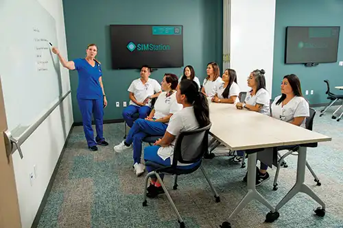 impage depicts instructor teaching students in classroom 